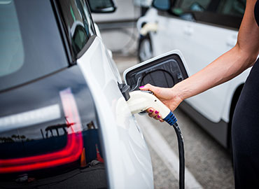 Person using an electric car charger